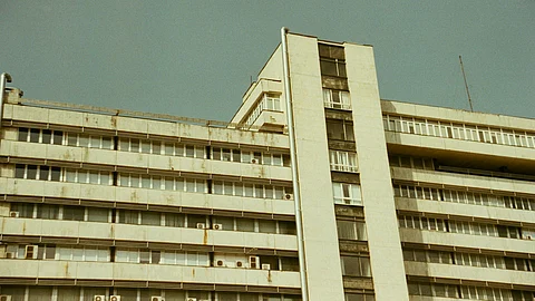 A building featuring a prominent clock representing hospital building.