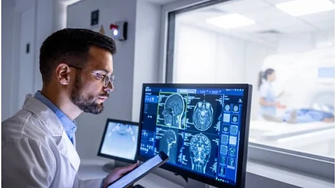 A healthcare professional in a white lab coat is trying to assess some brain scan images and reach a diagnosis.