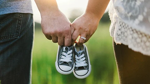 A couple with a child's shoes