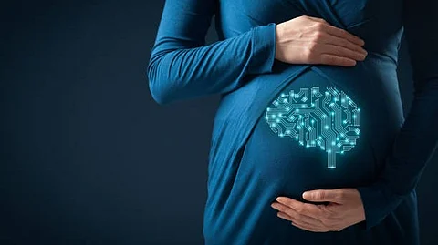 A pregnant woman in a blue dress cradles her belly, featuring a graphic of a brain made of circuit patterns.