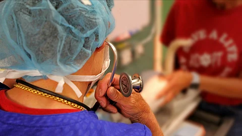 A image of doctor using stethoscope