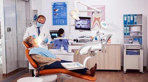 A dentist attending to a patient in a clinic.