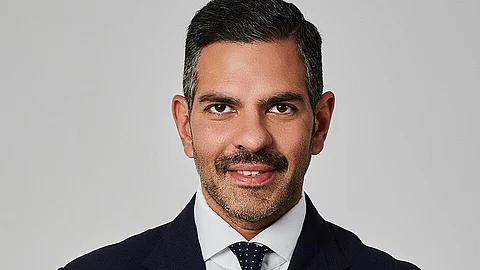 Sunjay Kapoor headshot wearing black suit and white shirt
