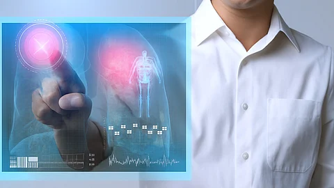 A doctor interacts with a digital medical screen, overlaying a human figure and X-ray image of lungs.