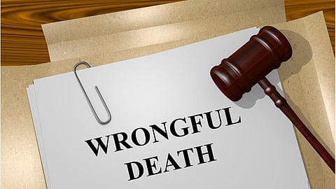 A Judge's gavel sitting on a document with a title 'wrongful death'.