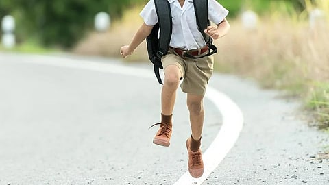 The image shows a happy boy running.