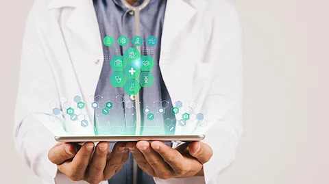 A doctor holding a tablet displaying AI-powered medical scribe apps.