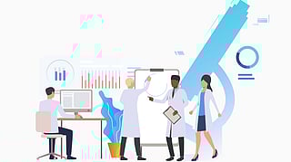 A group of people in lab coats gathers around a large whiteboard, discussing ideas and sharing information.