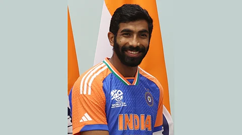 Picture of Jasprit Bumrah wearing the Indian Cricket Team jersey and smiling at the camera.