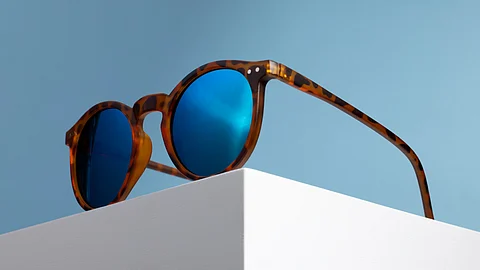 A blue tinted sunglasses with brown frame.