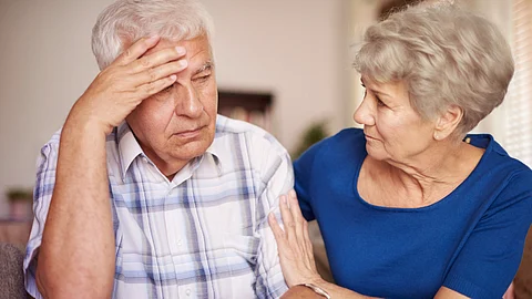 An elderly couple looking upset.