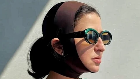 Image depicting woman wearing a SKIMS face wrap.