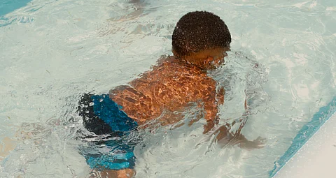 A toddler swimming in pool