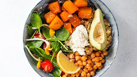 A salad bowl showing healthy, fiber-rich foods like avocado, spinach, cottage cheese, etc.