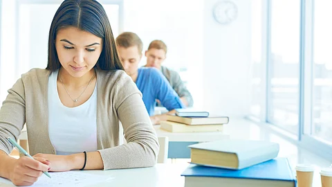 Front row of students writing an exam.