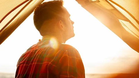 Image shows man standing in sunlight, highlighting the importance of vitamin D to prevent deficiency.