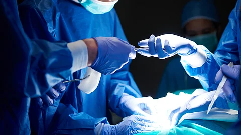A surgical team in an operation theatre doing a surgery.
