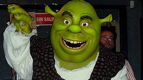 A person dressed up as 'Shrek' costume.