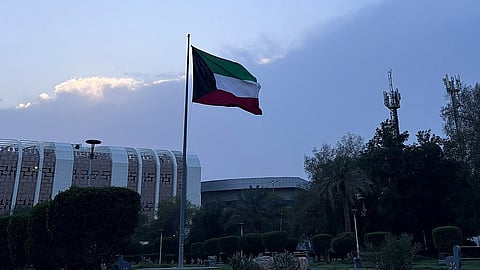 Kuwait flag flying on a pole at Kuwait