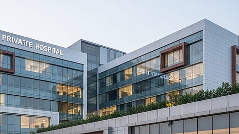 Image of a private hospital having glass windows and sky in the background.