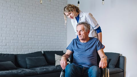 Old man getting senior care assistance by a healthcare service provider.