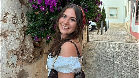An image of Lily before the surgery and illness in a white dress.