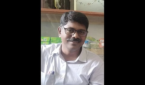 An image of Dr. Devan in a white shirt.