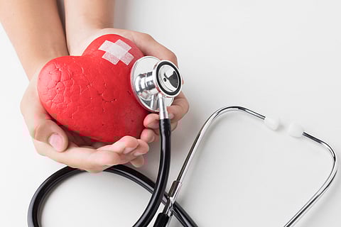 Image of a graphical red heart having band-aid over it with a stethoscope.