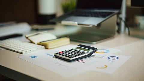 Representational image showing a calculator and some papers showing the benefits people will get from Nil GST on life and health insurance .