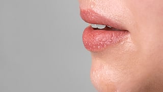 Image of a woman having water on her lips.