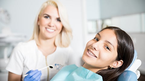 Image of a dentist treating a little girl.