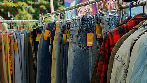 An image of thrifted jeans on racks.