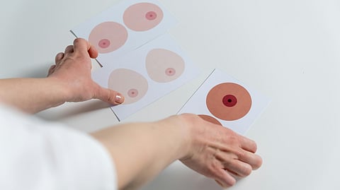 A healthcare professional discusses breast cancer screening options with a patient in a clinical setting.