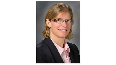 Image of the researcher of the study wearing a pink shirt and a blazer.