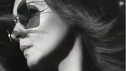 Black and white image of Pooja Bhatt wearing sunglasses.