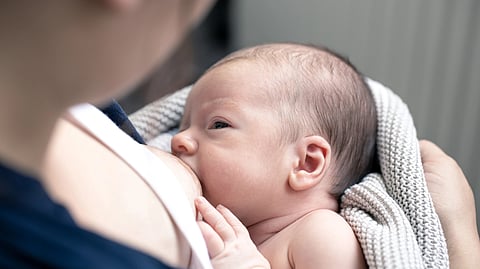 Image of a mother breastfeeding her child.