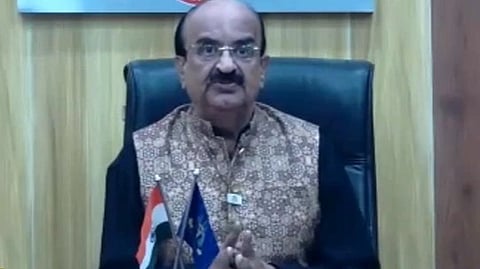 Image of Dr Dilip Bhanushali giving a speech while wearing formal attire.
