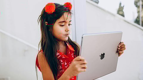 An image of a kid with an ipad.