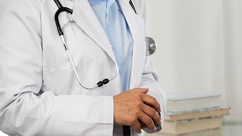 Close-up image of a doctor wearing a white coat and a stethoscope.