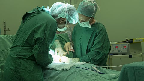 Two doctors performing a surgery.