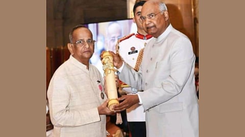 Dr. S. V. Adinarayana Rao receiving an award from a dignitary during a formal ceremony.