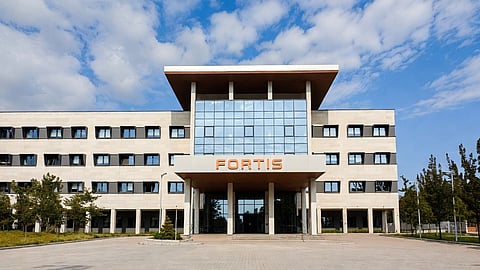 A hospital with a board saying FORTIS.