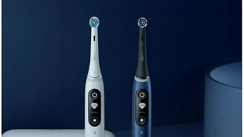 Two electric toothbrushes with round shaped end with bristles colored blue and white.