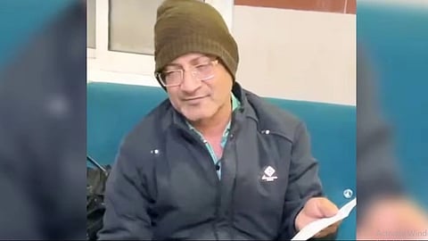 Drunk Doctor wearing a black jacket with a olive green cap.