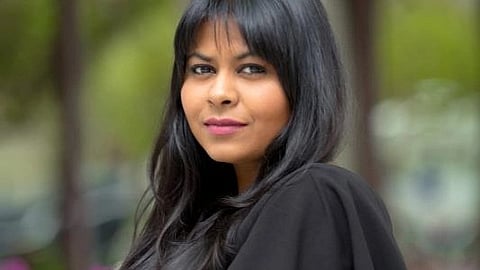 Portrait of Kanika Tekriwal wearing a black dress.