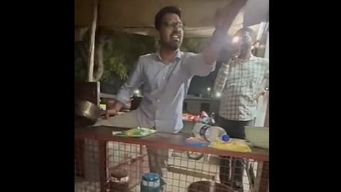 Doctor in white shirt shouting and throwing hands in air.