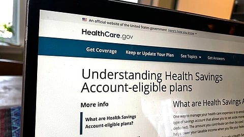 Laptop showing HealthCare.gov and HSA-eligible health plans.