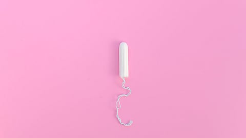 A tampon in a pink background.
