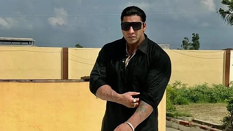Veer varinder in black top and sun glass.