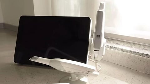 An intraoral scanner with a ipad or a screen attached with it.